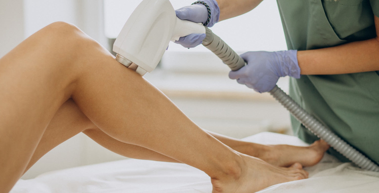 esthetician giving a woman laser hair removal treatment on their leg